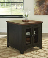 Set of two Ashley Furniture Valebeck End Tables with wooden surfaces and tapered legs, shown together in a cozy living room setting.