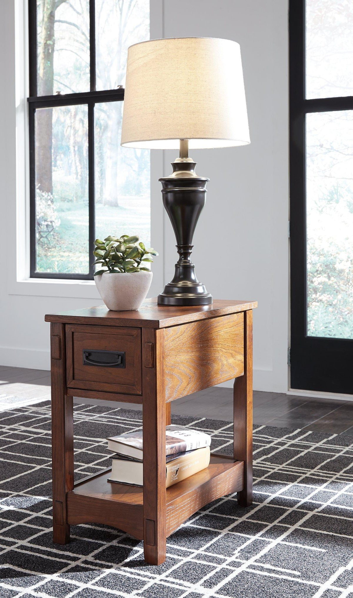 Set of Ashley Furniture Breegin end tables showing dark wood finish and modern design, with smooth surfaces and sturdy legs.