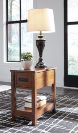 Set of Ashley Furniture Breegin end tables showing dark wood finish and modern design, with smooth surfaces and sturdy legs.