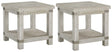 Ashley Furniture Carynhurst End Table Set featuring two stylish wooden tables with tapered legs and a warm finish.