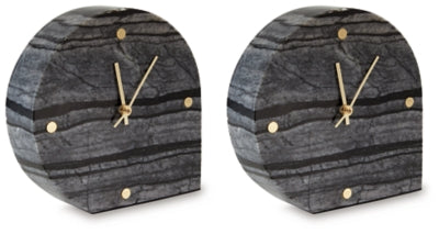 Two Ashley Furniture Janmour table clocks, stylish tabletop accessories with a modern design, displayed from an angled perspective.