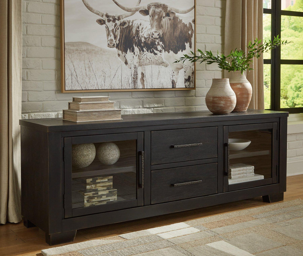 Ashley Furniture Galliden 80-inch TV stand with open shelves and storage drawers in a modern wood finish.