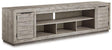 Ashley Furniture Naydell 92-inch TV stand with wood finish, storage compartments, and modern design for living room decor.