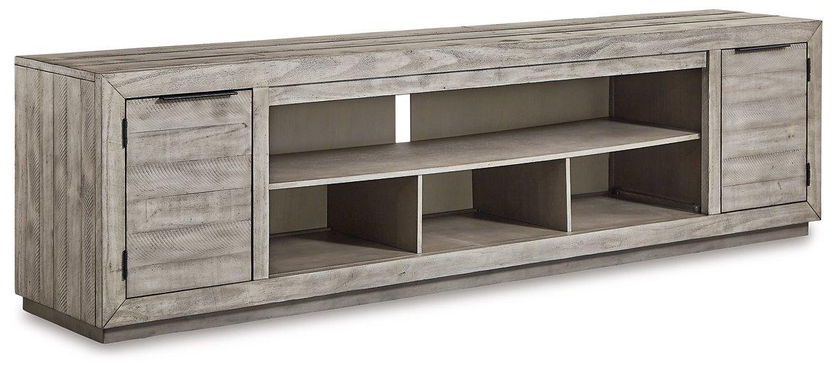 Ashley Furniture Naydell 92-inch TV stand with wood finish, storage compartments, and modern design for living room decor.