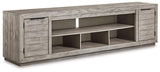 Ashley Furniture Naydell 92-inch TV stand with wood finish, storage compartments, and modern design for living room decor.