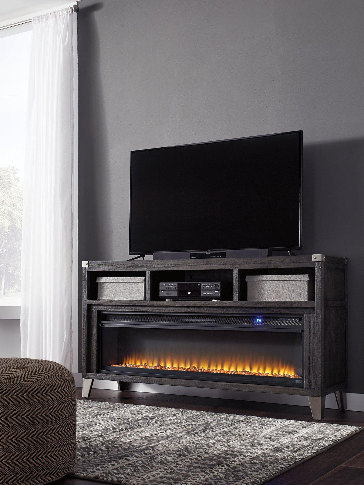 Ashley Furniture Todoe 65-inch TV stand with integrated electric fireplace, featuring a modern design and ample storage space.