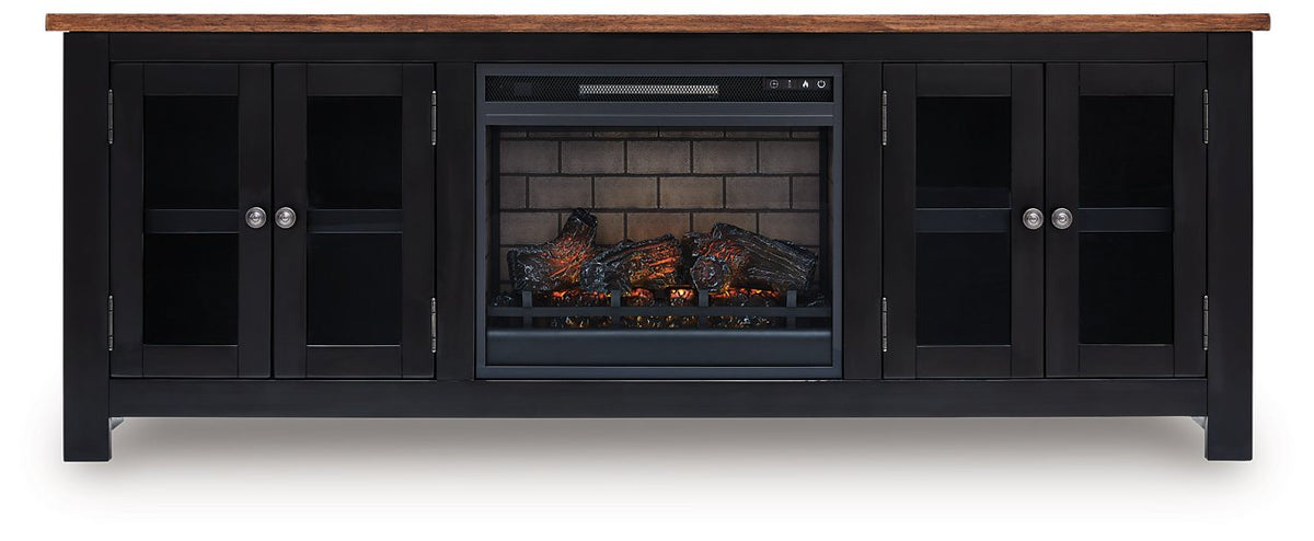 Wildenauer 76-inch TV stand with electric fireplace by Ashley Furniture, featuring a modern wood finish and built-in fireplace.