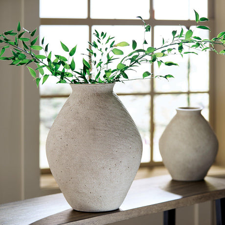 Hannela Vase by Ashley Furniture featuring a sleek, modern design with a smooth finish and neutral color for decorative use.
