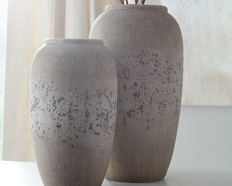Set of two Ashley Furniture Dimitra vases with sleek, modern design and neutral finish, perfect for decorative display.