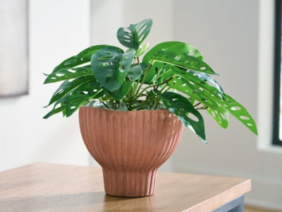 Ashley Furniture Orban Vase, decorative ceramic vase with textured design, shown in a natural setting.