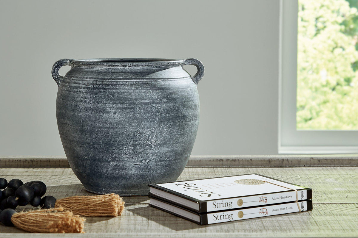 Ashley Furniture Meadie Vase with a sleek, modern design, showcasing a smooth, neutral-colored ceramic surface.