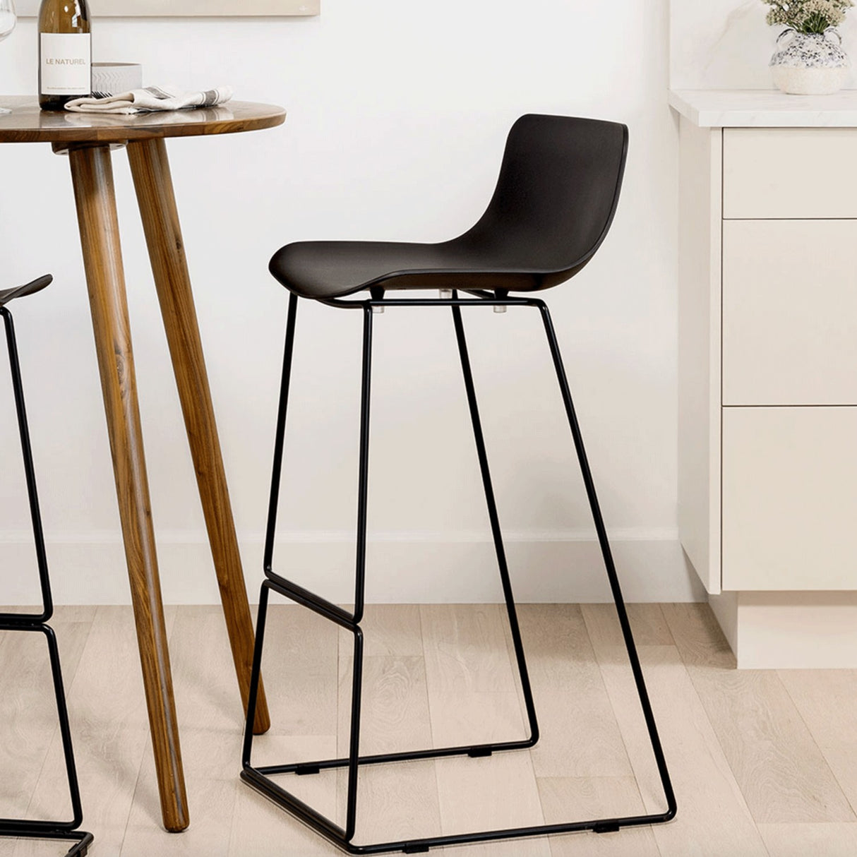 Black MCM indoor/outdoor barstool by Article with a sleek modern design and sturdy metal frame.