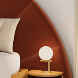 Gold MCM table lamp by Article featuring a sleek, modern design with a round base and contemporary aesthetic.