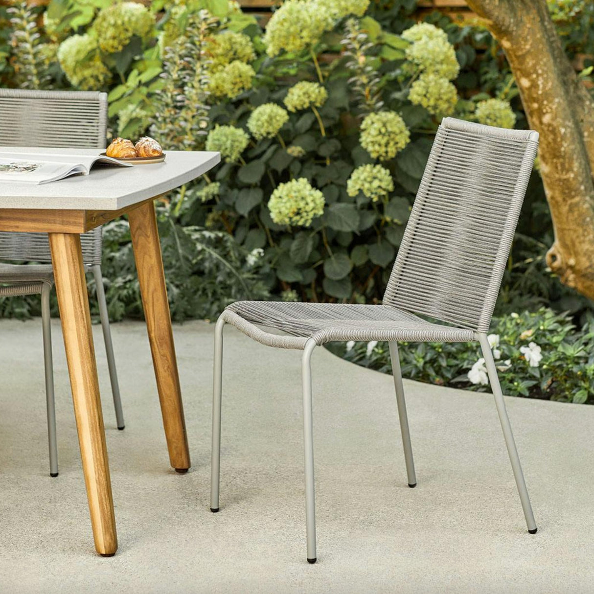Heathered gray MCM dining chair by Article, stackable modern dining chair with sleek design and wooden legs.