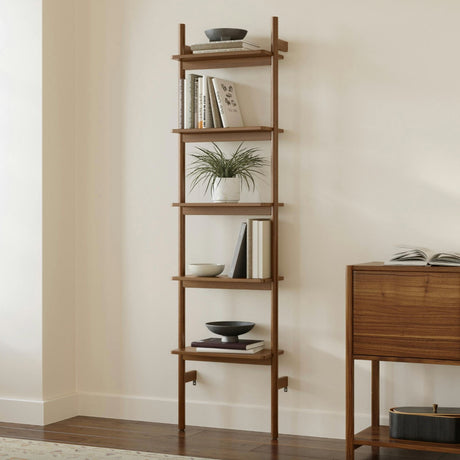 Narrow walnut MCM-style bookshelf by Article with multiple shelves for books and decor display.
