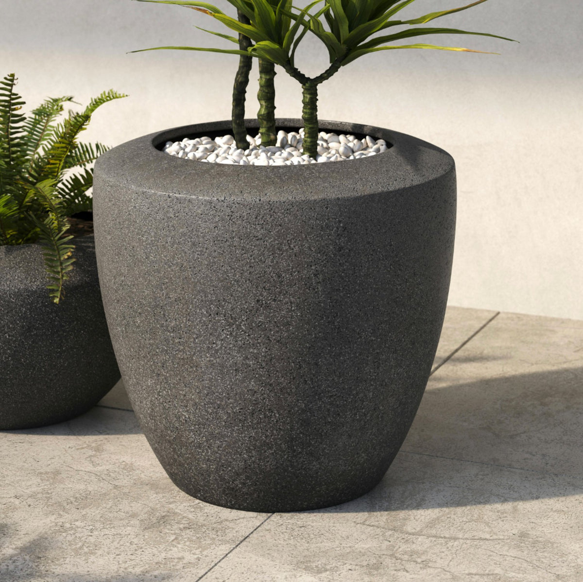 Large charcoal indoor/outdoor planter by Article, showcasing a modern, cylindrical design with a smooth matte finish.