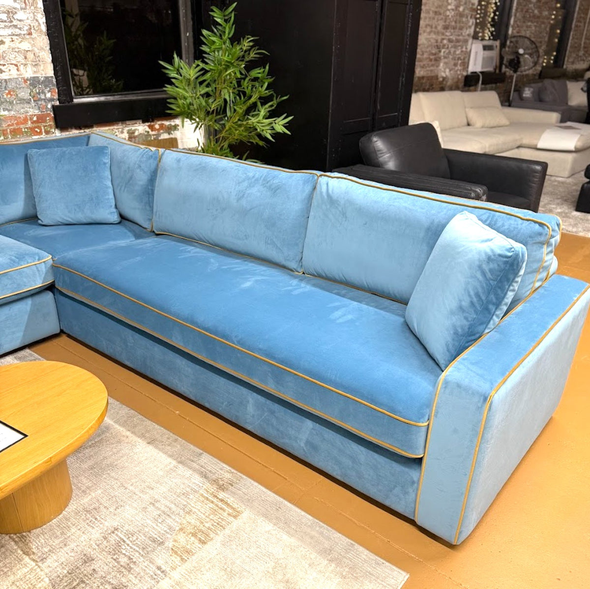 Interior Define James 5-Piece Blue Velvet Sectional sofa with plush cushions and modern design in a living room setting.