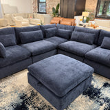 Pull Up A Couch Serenity Cloud blue 5-piece corner sectional with storage ottoman, showcasing plush fabric and modern design.