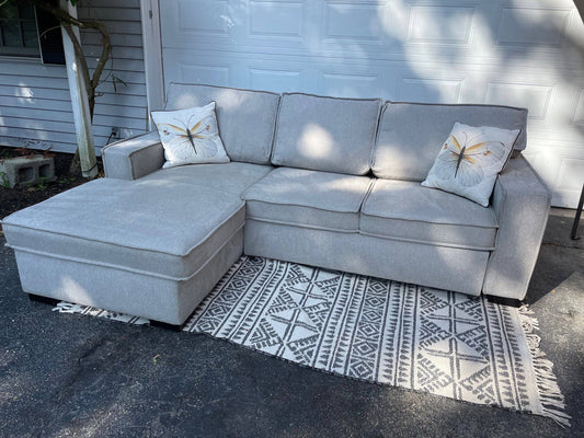 Gray 2 piece sectional with left-facing chaise, storage, and pop-up sleeper - Pull Up A Couch