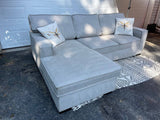 Gray 2 piece sectional with left-facing chaise, storage, and pop-up sleeper - Pull Up A Couch