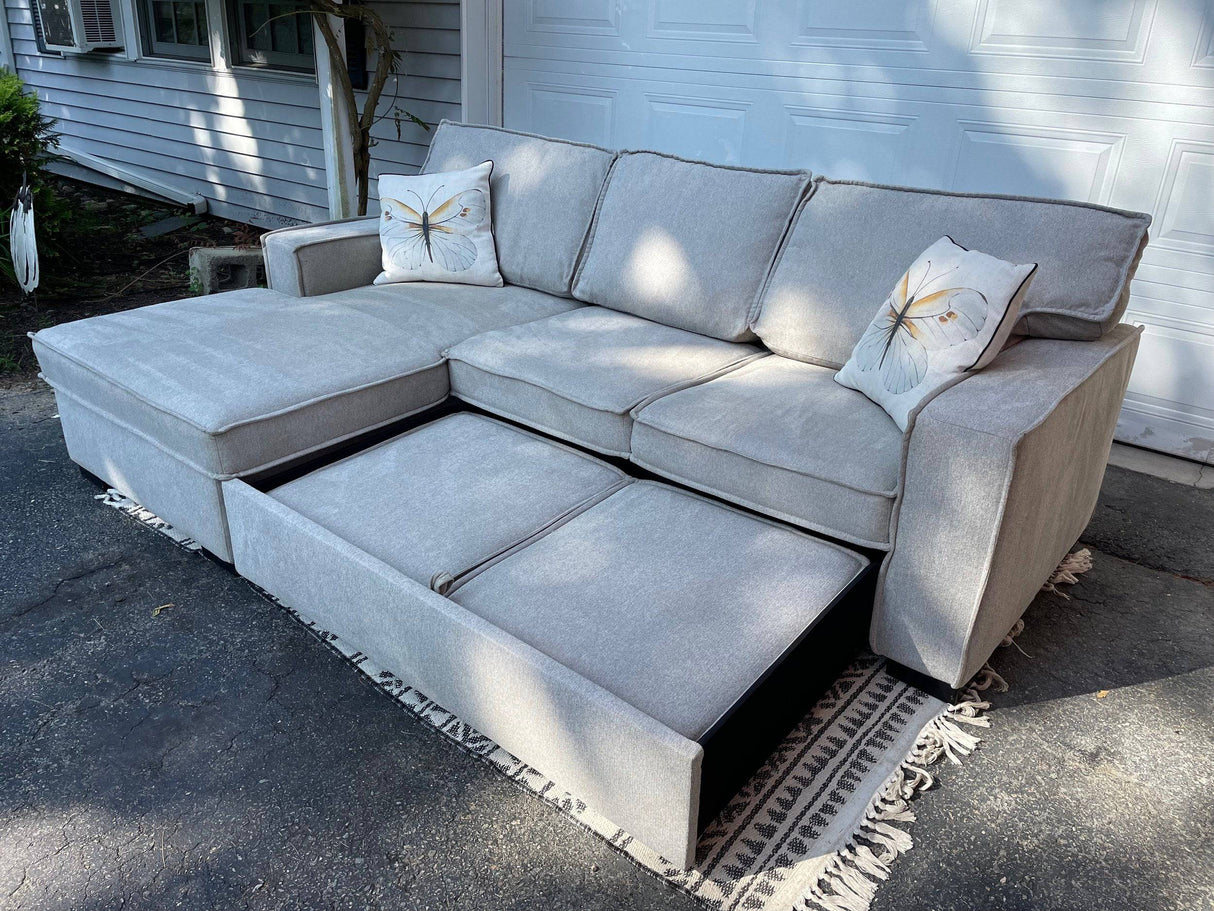 Gray 2 piece sectional with left-facing chaise, storage, and pop-up sleeper - Pull Up A Couch